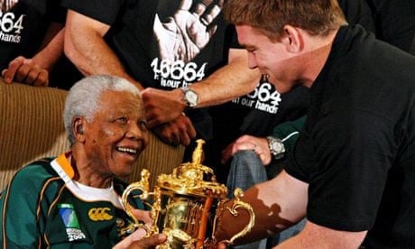 Springboks captain John Smit hands the rugby World Cup trophy to Nelson Mandela 