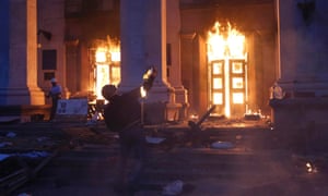 A protester throws a petrol bomb at the trade union building in Odessa.