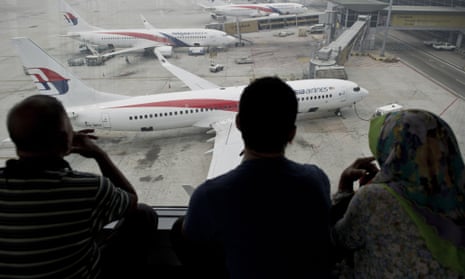 People watch Malaysia Airlines planes on the tarmac at Kuala Lumpur airport.