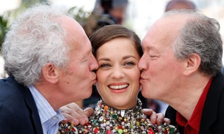Belgian director Luc Dardenne (R) and Belgian director Jean-Pierre Dardenne kiss Marion Cotillard (C) during a photocall for the film Two Days One Night