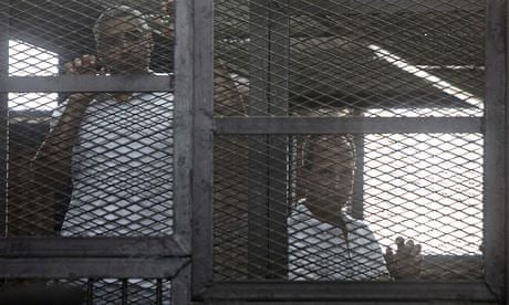 Australian journalist Peter Greste and an al-Jazeera colleagues during their trial in Egypt