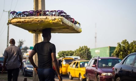 A man selling sunglasses in a Lagos traffic-jam.