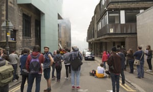 Students gather near the scene of the fire.