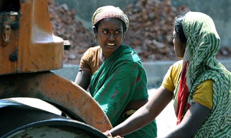 Indian women labourers push a rolling ma
