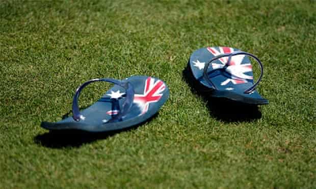 Thongs with Australian flags sit on the field
