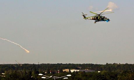 A Ukrainian helicopter gunship fires decoy flares after attacking Donetsk international airport