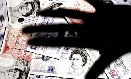 shadow of hand over a pile of GBP banknotes