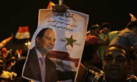 A supporter holds up a poster of Egypt's former army chief Sisi 