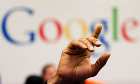 hand raised in front of Google logo