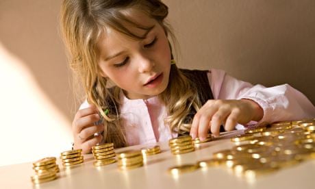 young girl counting her money on table
