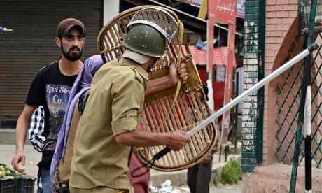 Kashmiri Muslims confront Indian policemen after they arrested a youth during a protest