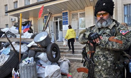 A pro-Russia militant guards a barricade outside Kramatorsk city hall, eastern Ukraine