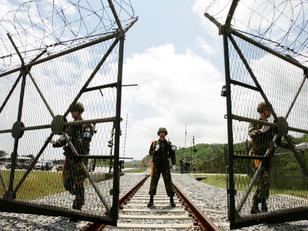 South Korean soldiers open the gate for a North Korean train to pass near the demilitarized zone (DMZ).