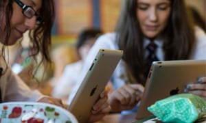 Schoolgirls using iPad