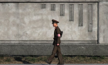 A North Korean soldier patrols on the banks of the Yalu River near the North Korean town of Sinuiju, opposite Dandong.