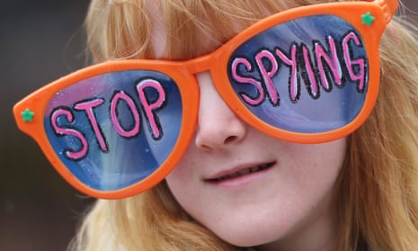 A woman wears large sunglasses with a message during a rally to call for an end to government surveillance on March 28, 2014 in Lafayette Square in Washington.