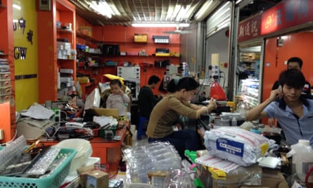 Family workshop inside a Huaqiangbei mobile phone market, Shenzhen, China.
