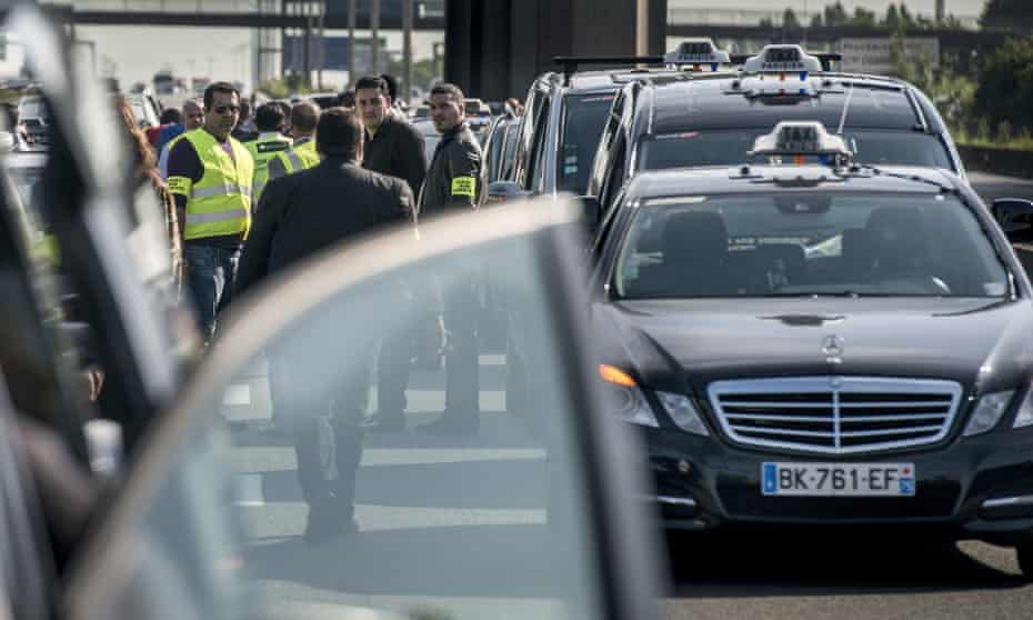 Taxis drivers block highway outside Paris as they take part in a demonstration against Uber on June 11.