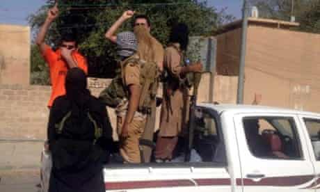 epa04250426 Iraqi Sunni gunmen drive in a pickup truck on a street in Tikrit, northern Iraq, 11 June 2014.