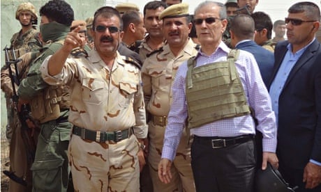 Kirkuk province's Kurdish governor Najim al-Din Omar Karim with a peshmerga commander