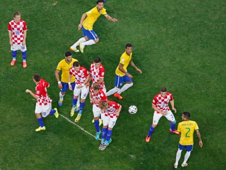 Croatia's play kleap from behind a line of vanishing spray as a free-kick is taken.