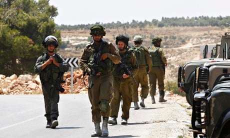 Israeli soldiers patrol near the West Bank city of Hebron