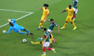 Oribe Peralta scores the opening goal past Charles Itandje.