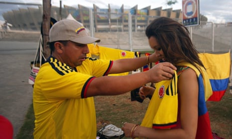 A Colombia fan, right, buys a shirt outside Estádio Mineirão in Belo Horizonte, before the game with Greece.