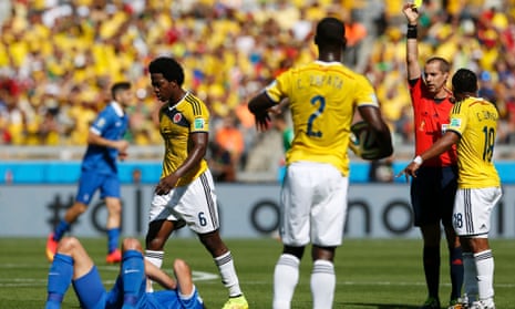 Colombia's Carlos Sanchez walks away after receiving a yellow card from referee Mark Geiger.