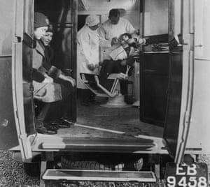 Dentists go mobile - A dentist treats a young girl in a mobile surgery operated for the benefit of local schoolchildren in Cambridgeshire, 1931.