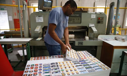 Cutting the stickers in a guillotine at the Panini factory.
