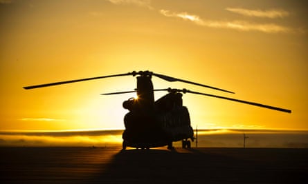 A British Royal Airforce (RAF) Chinook helicopter, during the sunrise, on the line at RAF Odiham.