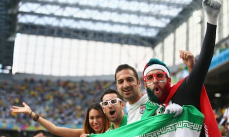 Iran fans cheer at Arena da Baixada.
