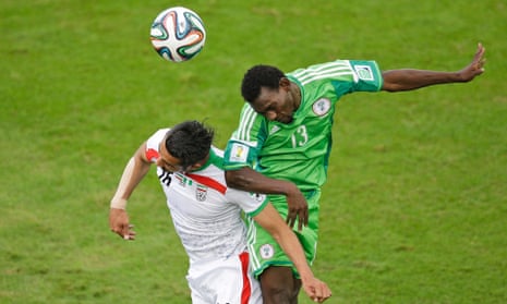 Iran's Reza Ghoochannejhad and Nigeria's Juwon Oshaniwa battle for a header.