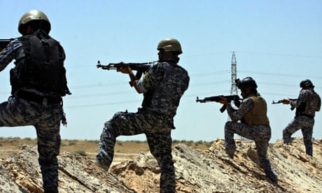 Iraqi security forces patrol near the border between Karbala province and Anbar province today