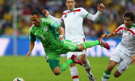 Peter Odemwingie of Nigeria falls after a challenge by Andranik Teymourian