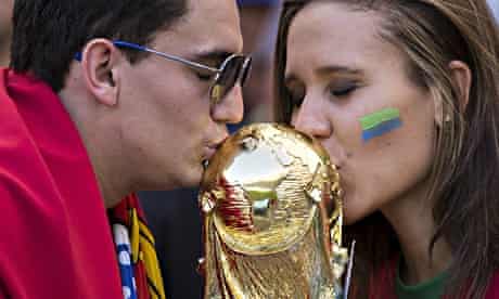 Portugal fans kiss a replica of the World Cup trophy in Brazil, 2014