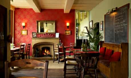 Fireplace, chairs and a pew at the Parkers Arms, in Lancashire