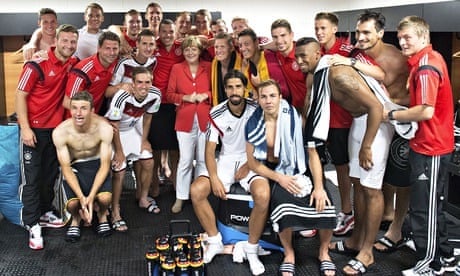 Angela Merkel celebrates with the German football team after their World Cup victory over Portugal