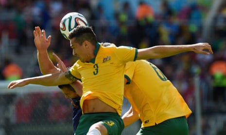 Australia's defender Jason Davidson heads the ball as the game gets under way.