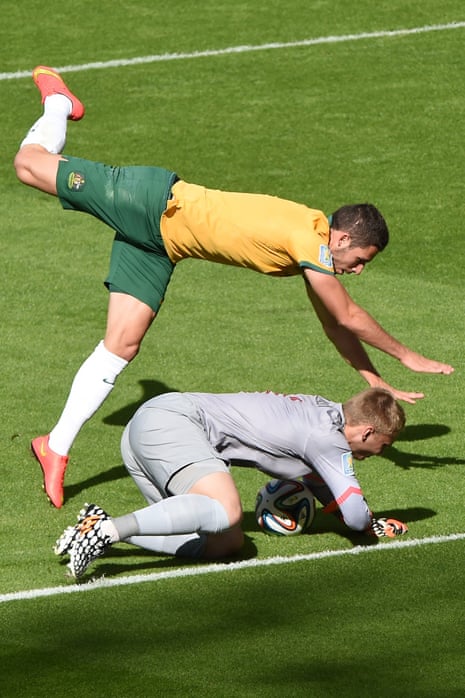 Netherlands' goalkeeper Jasper Cillessen (bottom) vies with Australia's forward Mathew Leckie.