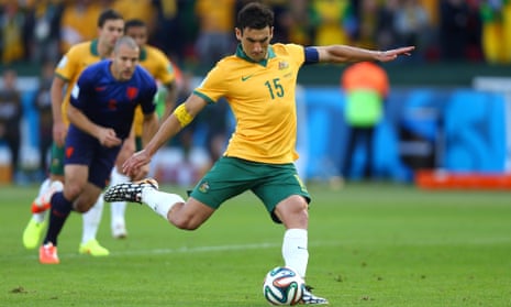 Mile Jedinak of Australia shoots and scores the penalty.