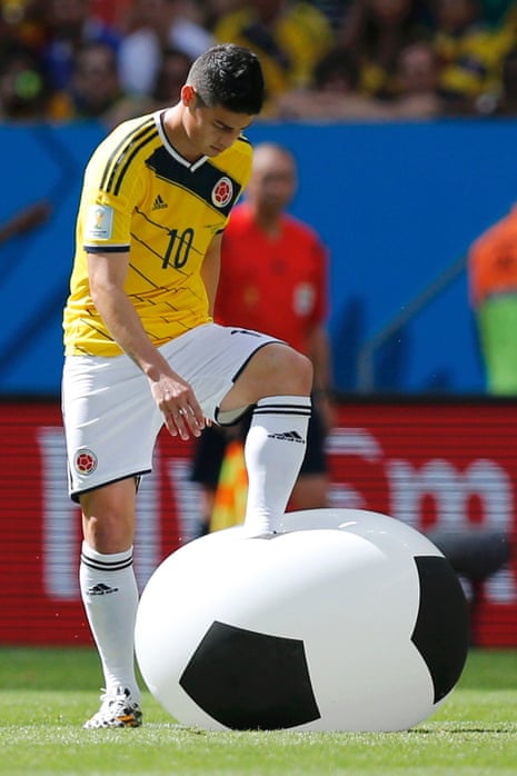 Colombia's James Rodriguez attempts to burst the inflatable ball.