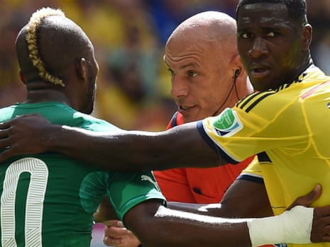 English referee Howard Webb has a quiet word with Geoffroy Serey Die and Cristian Zapata.