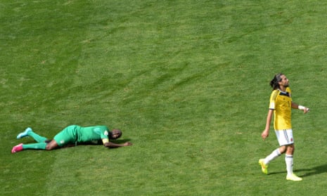Ivory Coast's midfielder Yaya Toure hits the ground whilst Colombia's defender and captain Mario Alberto Yepes walks away.