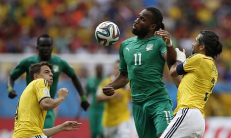 Ivory Coast's forward and captain Didier Drogba  fights for the bal.