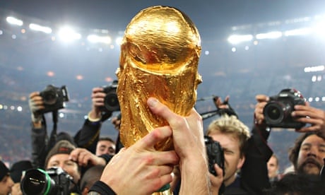 SWINDON, UK - JUNE 11, 2014: FIFA World Cup Trophy And Adidas Brazuca  Football On A White Background, FIFA World Cup Trophy, Was Introduced In  1974. Made Of 18 Carat Gold With