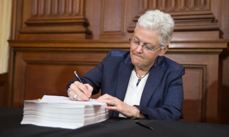 Environmental Protection Agency (EPA) Administrator Gina McCarthy signs new emission guidelines during an announcement of a plan to cut carbon dioxide emissions from power plants by 30 percent by 2030, Monday, June 2, 2014, at EPA headquarters in Washington.