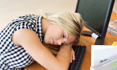 A teenage girl asleep at a computer.