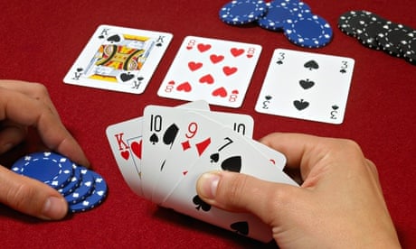 Poker hand with players hands against red baize